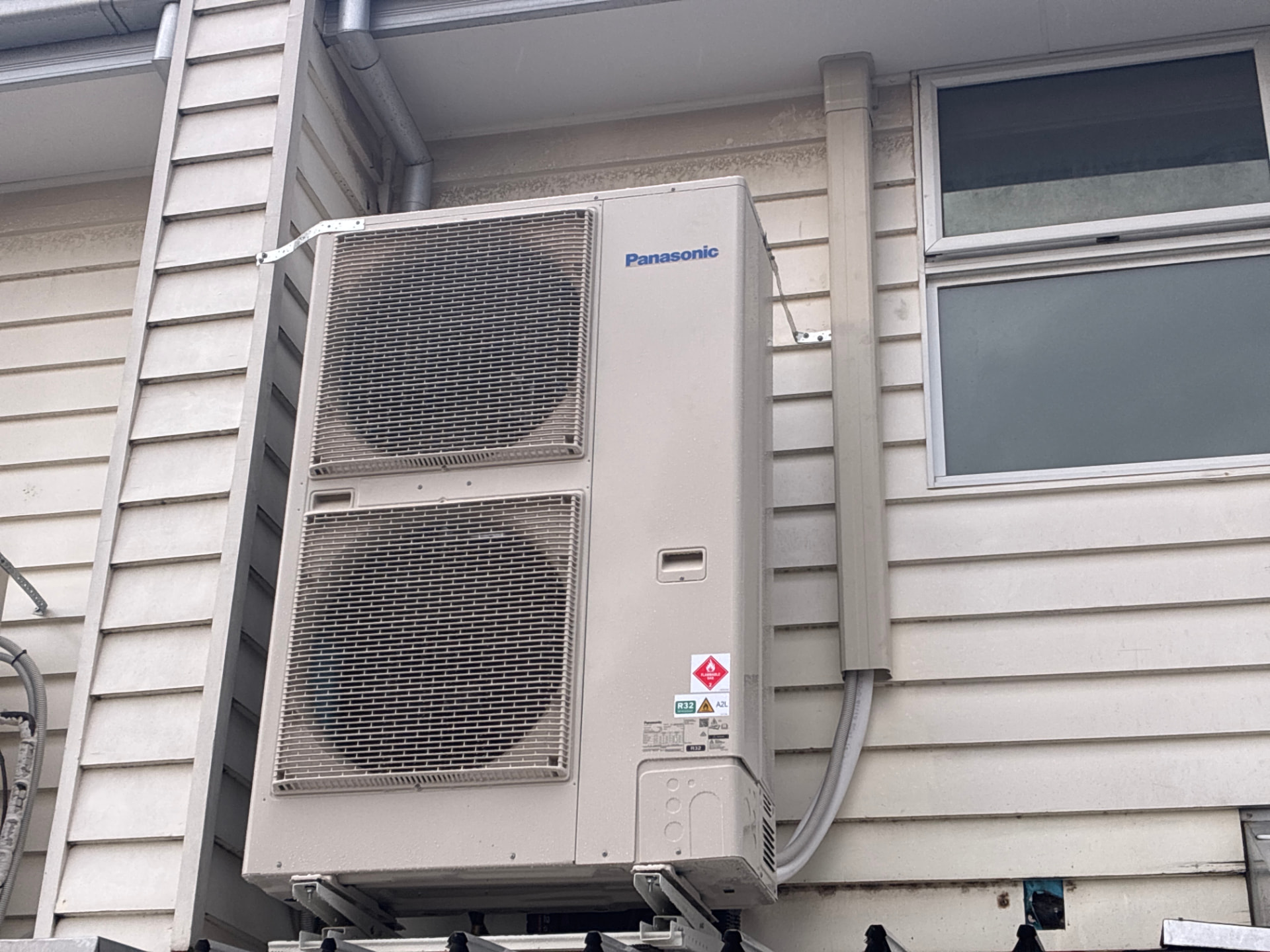 Bracket-mounted install on a weatherboard home